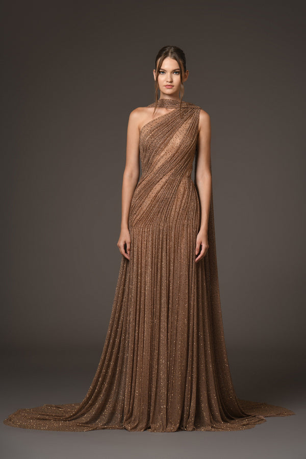 Asymmetrical halter gown draped in bronze silk tulle, adorned with antique gold crystals