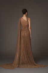 Asymmetrical halter gown draped in bronze tulle, with antique gold crystals back view