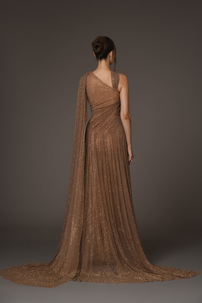 Asymmetrical halter gown draped in bronze tulle, with antique gold crystals back view