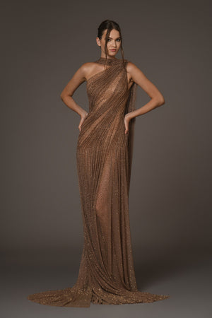 Asymmetrical halter gown draped in bronze silk tulle, adorned with antique gold crystals