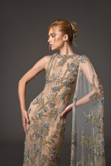 nude tulle dress with flower embroidery and a cape close up