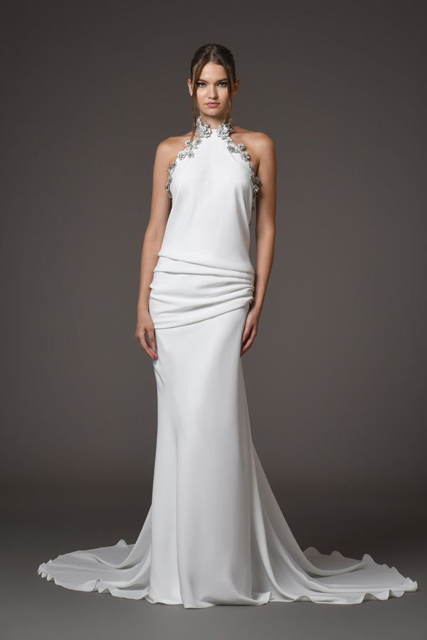 white gown with silver metal flower detailing on the halter neck 