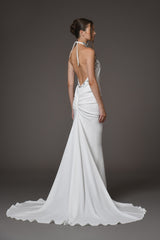 white gown with silver metal flower detailing on the halter neck with an open back and train