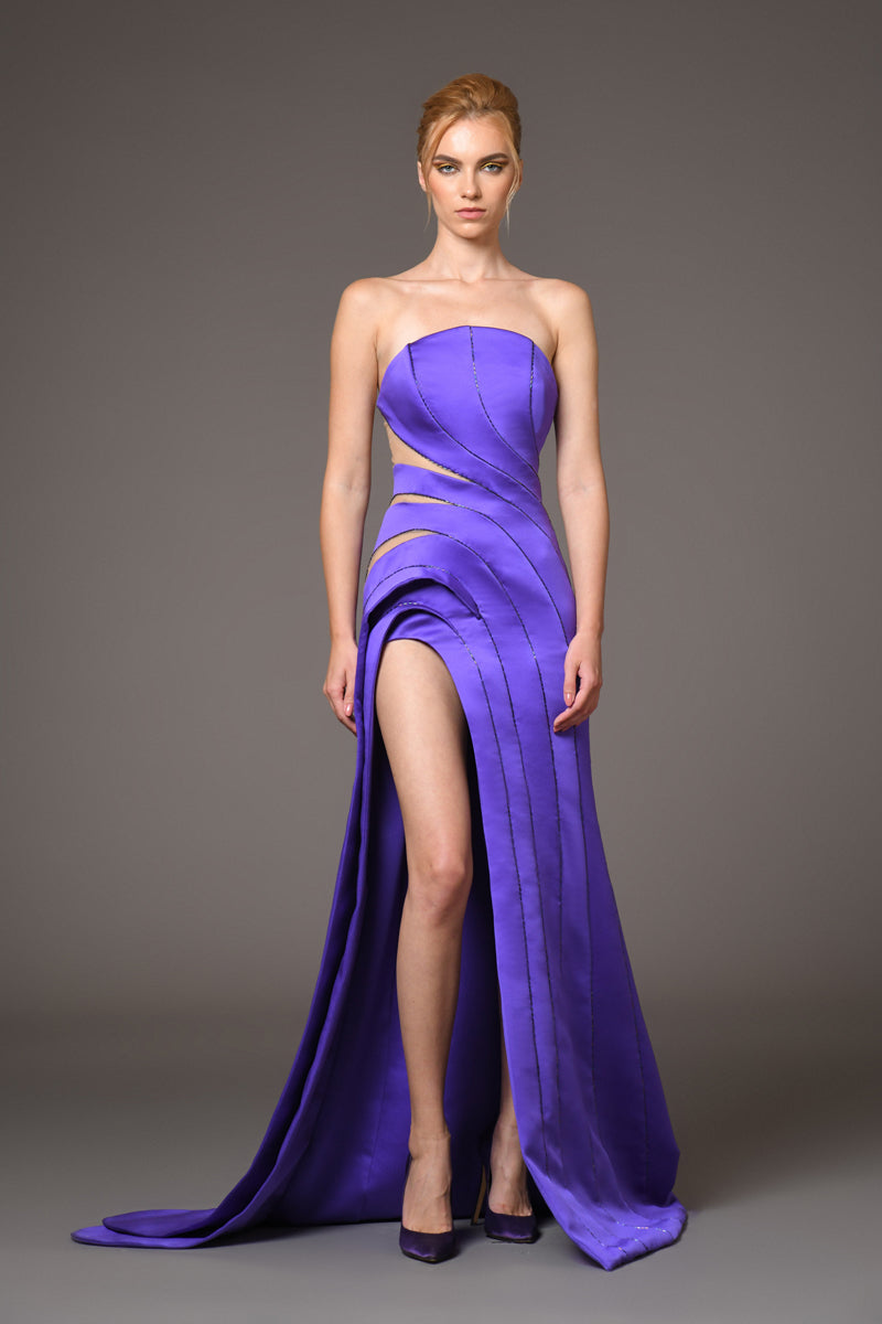 strapless purple gown with cut out detailing and high thigh slit