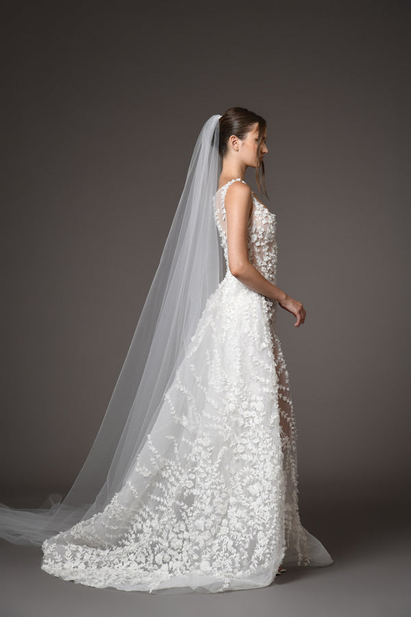 tulle bridal gown with floral embroidery with an overskirt side view with a little train