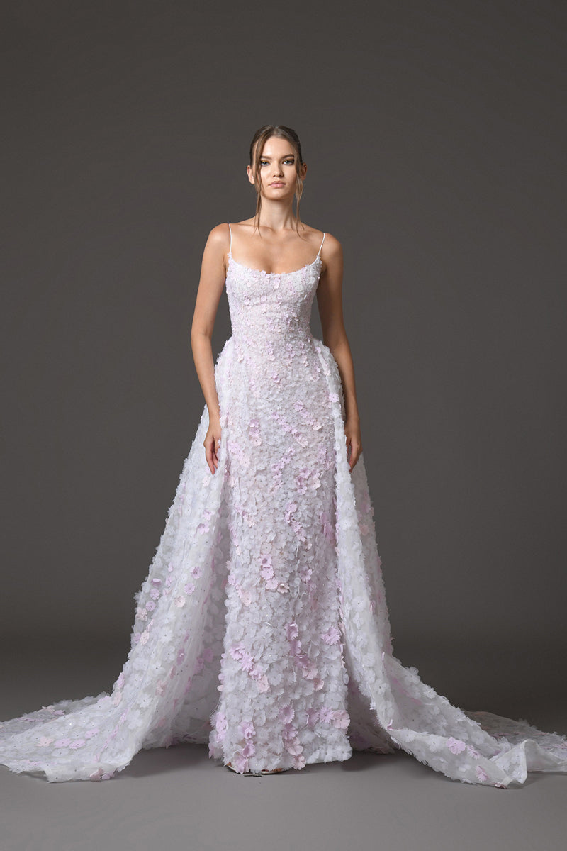 White tulle bridal gown fully embroidered with white and light pink floral bouquets with layered overskirt