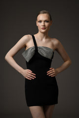 Short black crêpe dress featuring a crystal bow