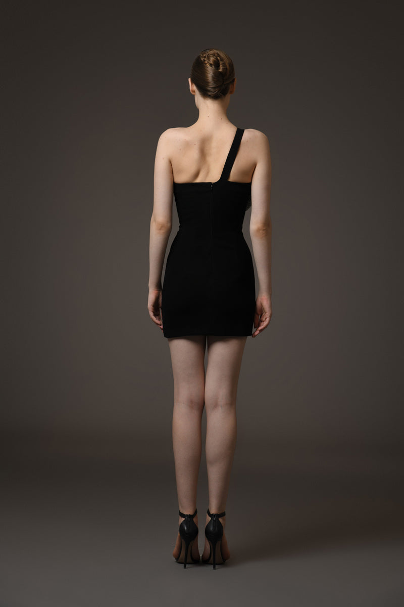 Short black crêpe dress featuring a crystal bow