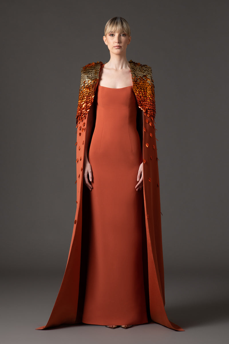 Burnt brick crêpe dress with 3D leaf embellishment paired with a cape