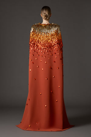 Burnt brick crêpe dress with 3D leaf embellishment paired with a cape