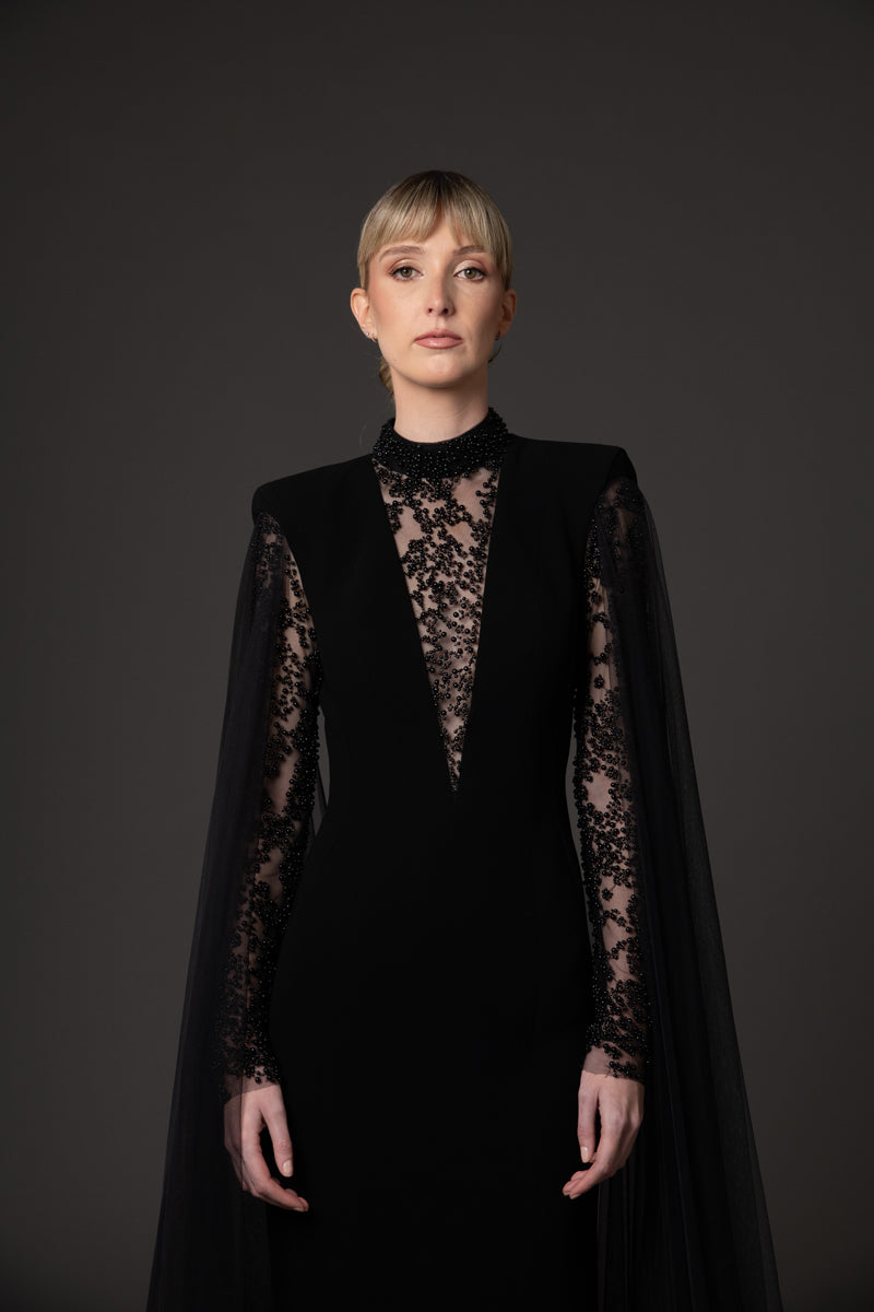 Black crêpe dress with embroidered detailing and cape sleeves