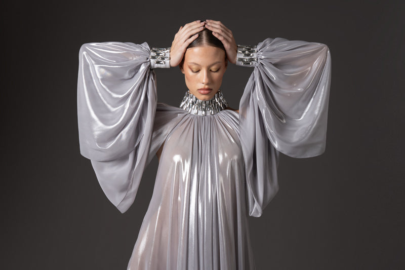 Silver chiffon lamé dress with halter neck and sleeves, featuring baguette embroidery  on neckline and cuffs