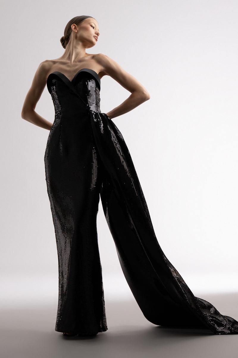 Strapless black sequin dress , featuring a one sided overskirt and a satin bustline