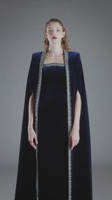 Embroidered velvet blue dress paired with a cape‭