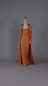 Burnt brick crêpe dress with 3D leaf embellishment paired with a cape