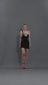 Short black crêpe dress featuring a crystal bow