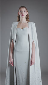 Embroidered light grey crêpe dress paired with a cape