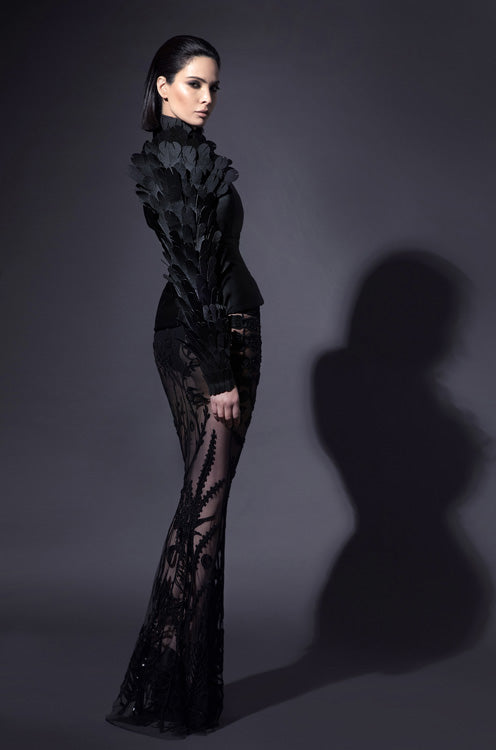 Black tailored blazer in silk scuba with armour sleeve in laser-cut plumes and a silk tulle skirt swarming with Mesopotamian mythological creatures