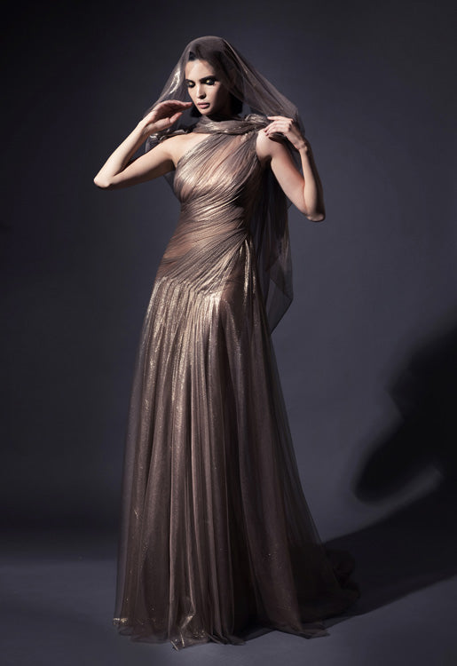 Exquisitely draped asymmetrical halter gown with caped open sleeve in fairy-spun bronze foiled silk tulle