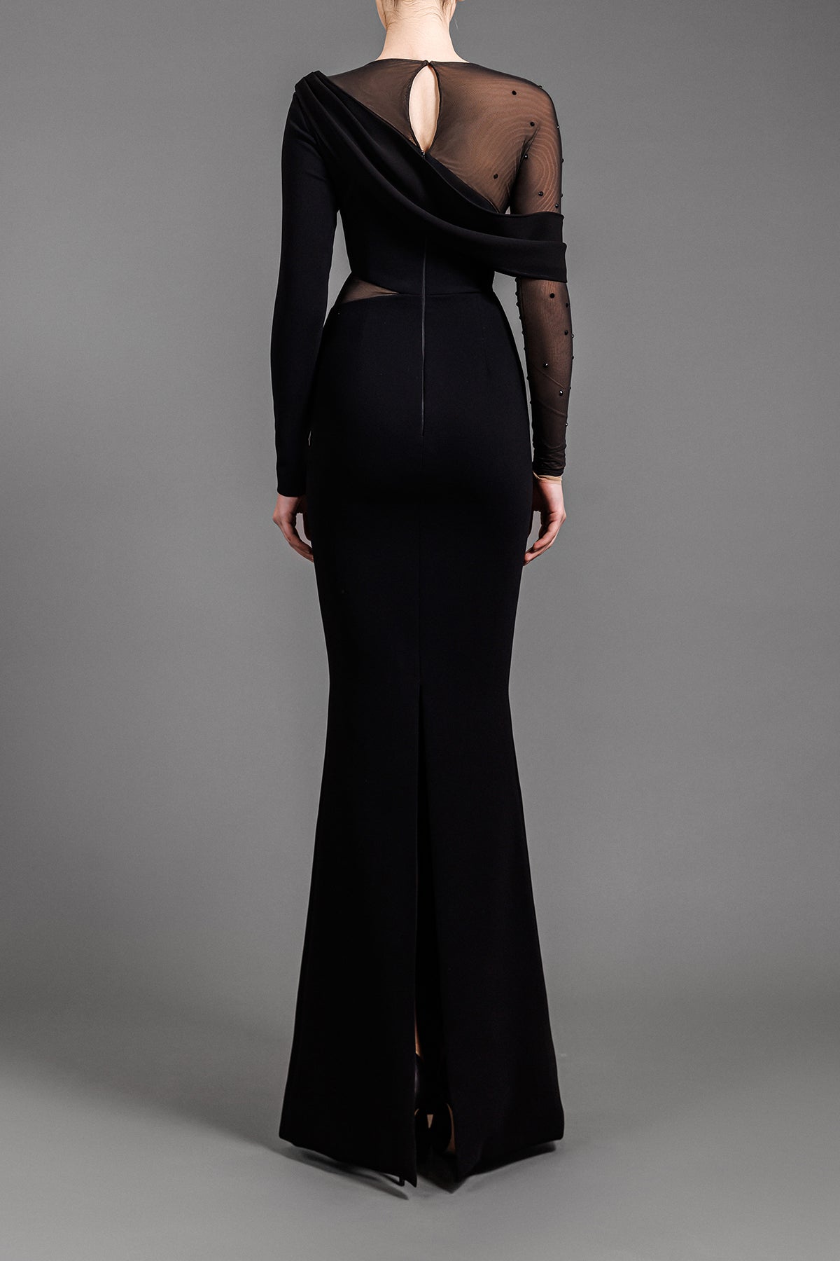 Long sleeved asymmetrical black crêpe dress with tulle and black crystals