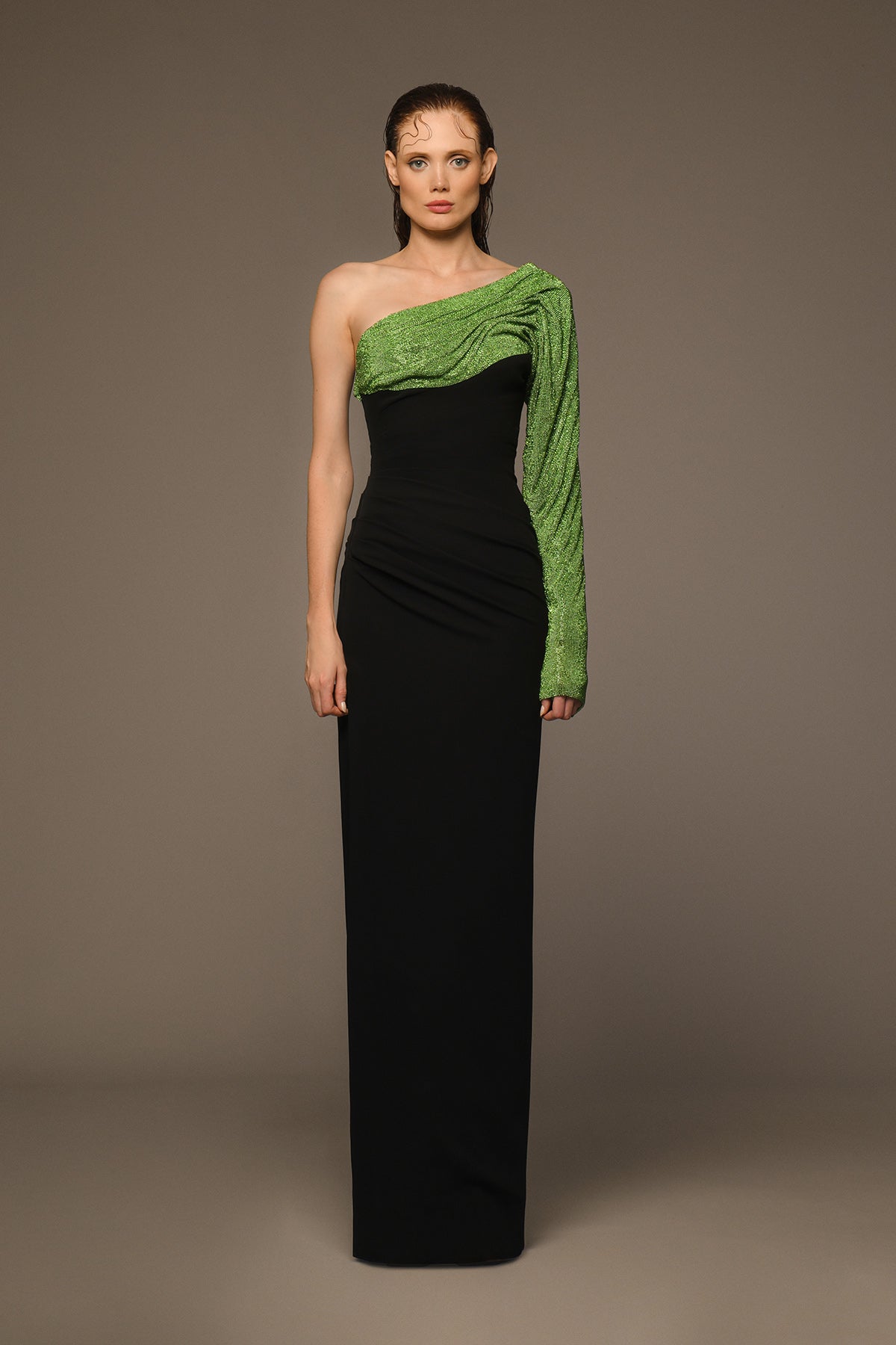 Asymmetrical black crêpe dress with green crystal chainmail