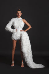 White mini dress in layered plumes featuring an embroidered neckline and a dramatic wing-shaped overskirt