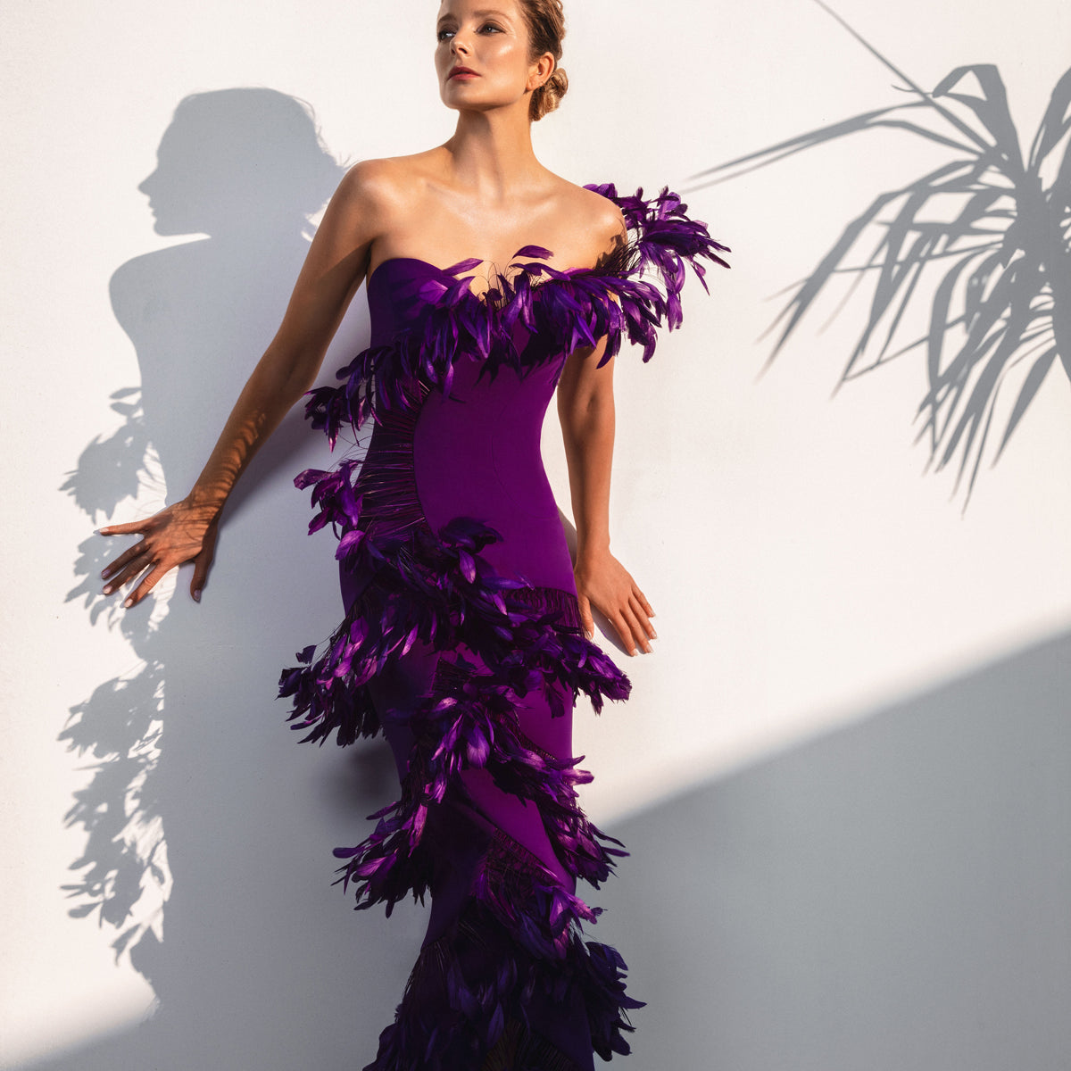 Asymmetrical purple dress with layered feathers