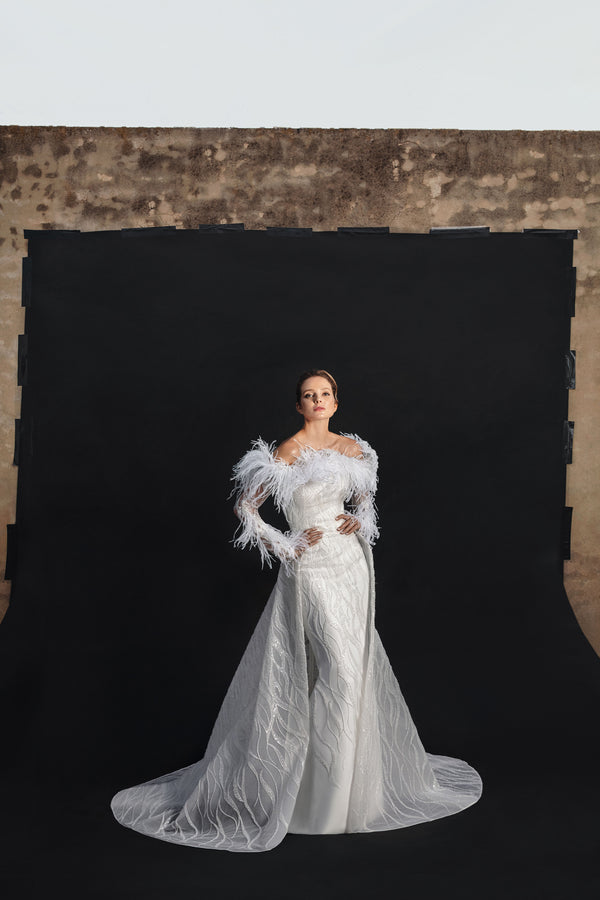Off-white tulle embroidered bridal gown with off the shoulders feathers