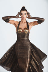 Sleeveless slinky gown with an exploded bow-back ruffle in bronze foiled silk tulle featuring scallop shells handcrafted from solid brass and finished with hand-applied antique gold