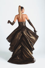 Slinky gown with an exploded bow-back ruffle in bronze foiled silk tulle featuring scallop shells handcrafted from solid brass and finished with hand-applied antique gold