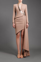 Nude ensemble with a structured blazer featuring a metal detail and draped skirt