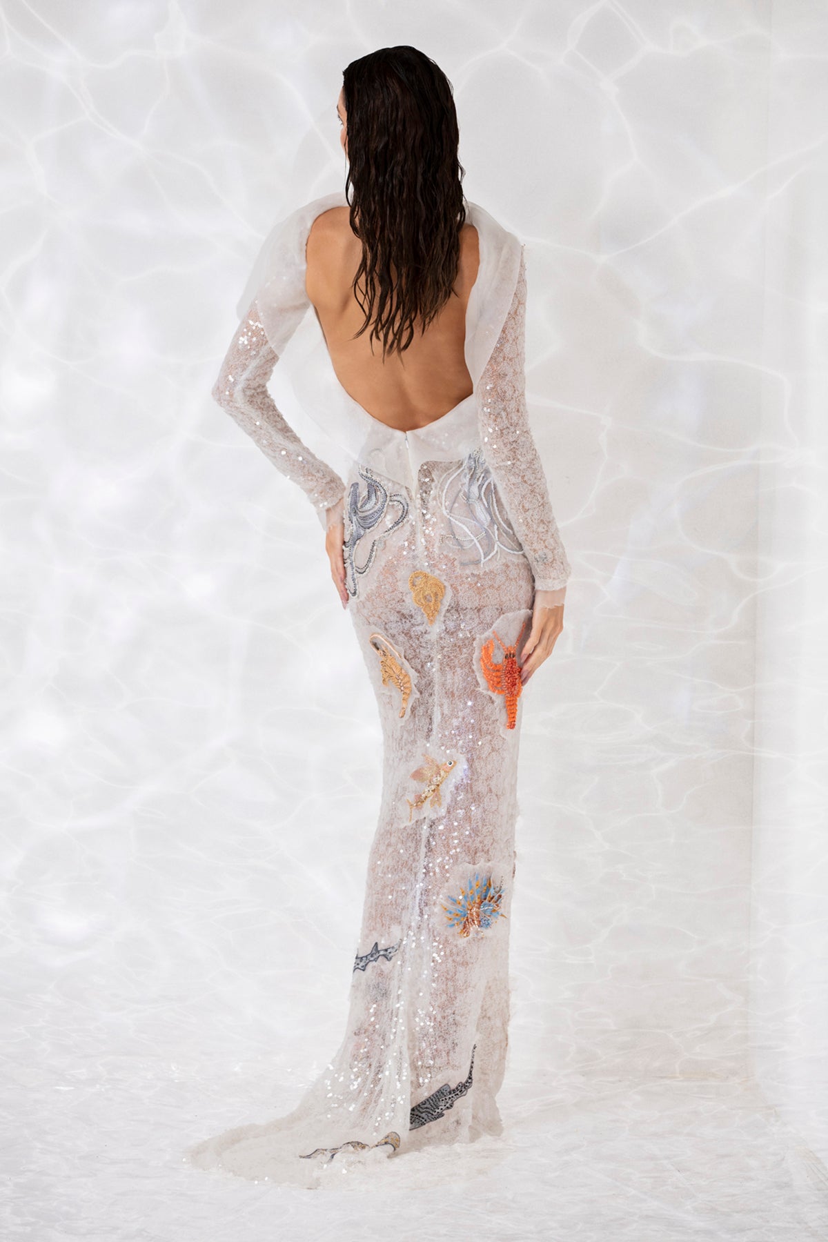 Patchwork of seashells and underwater creature embroidered onto a sequined white sheer tulle dress Patchwork of seashells and underwater creature embroidered onto a sequined white sheer tulle dress