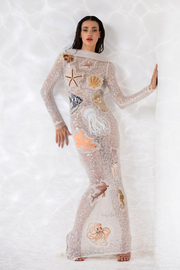 Patchwork  of seashells and underwater creature embroidered onto a sequined white sheer tulle dress