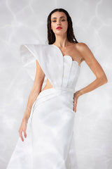 One shoulder silky crêpe dress with a scallop shell inspired bustier and a layered overskirt in pearl white scuba