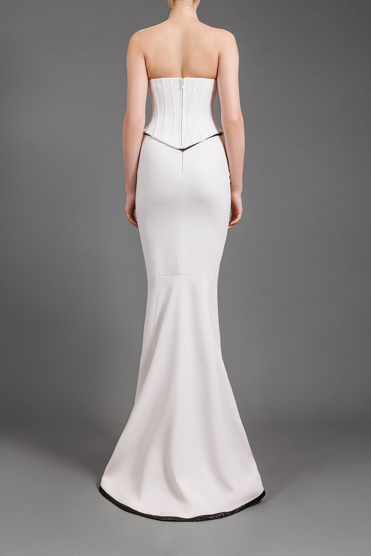 White crêpe mermaid skirt with black shimmery detailing and a structured corset 