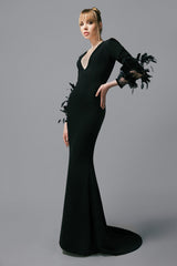 Long sleeved black crêpe dress with feathers on the sleeves