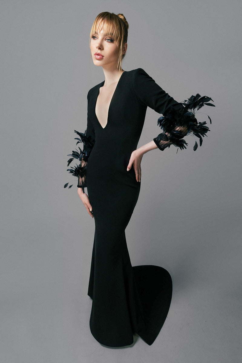 Mermaid cut black crêpe dress with feathers on the sleeves