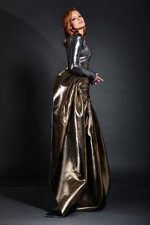 Gunmetal lamé one shoulder bustier accompanied by a pleated gold lamé skirt 