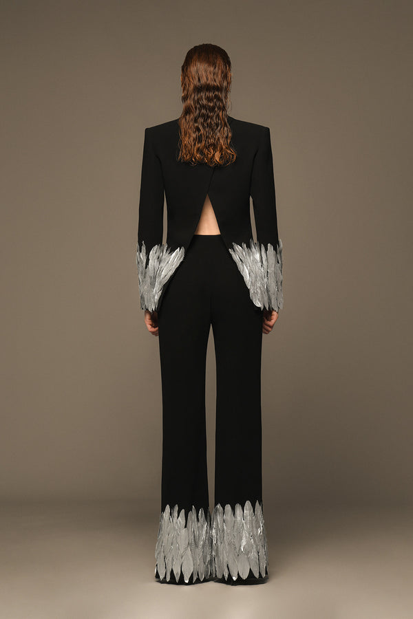 Structured black suit with silver painted feathers on sleeves and hem