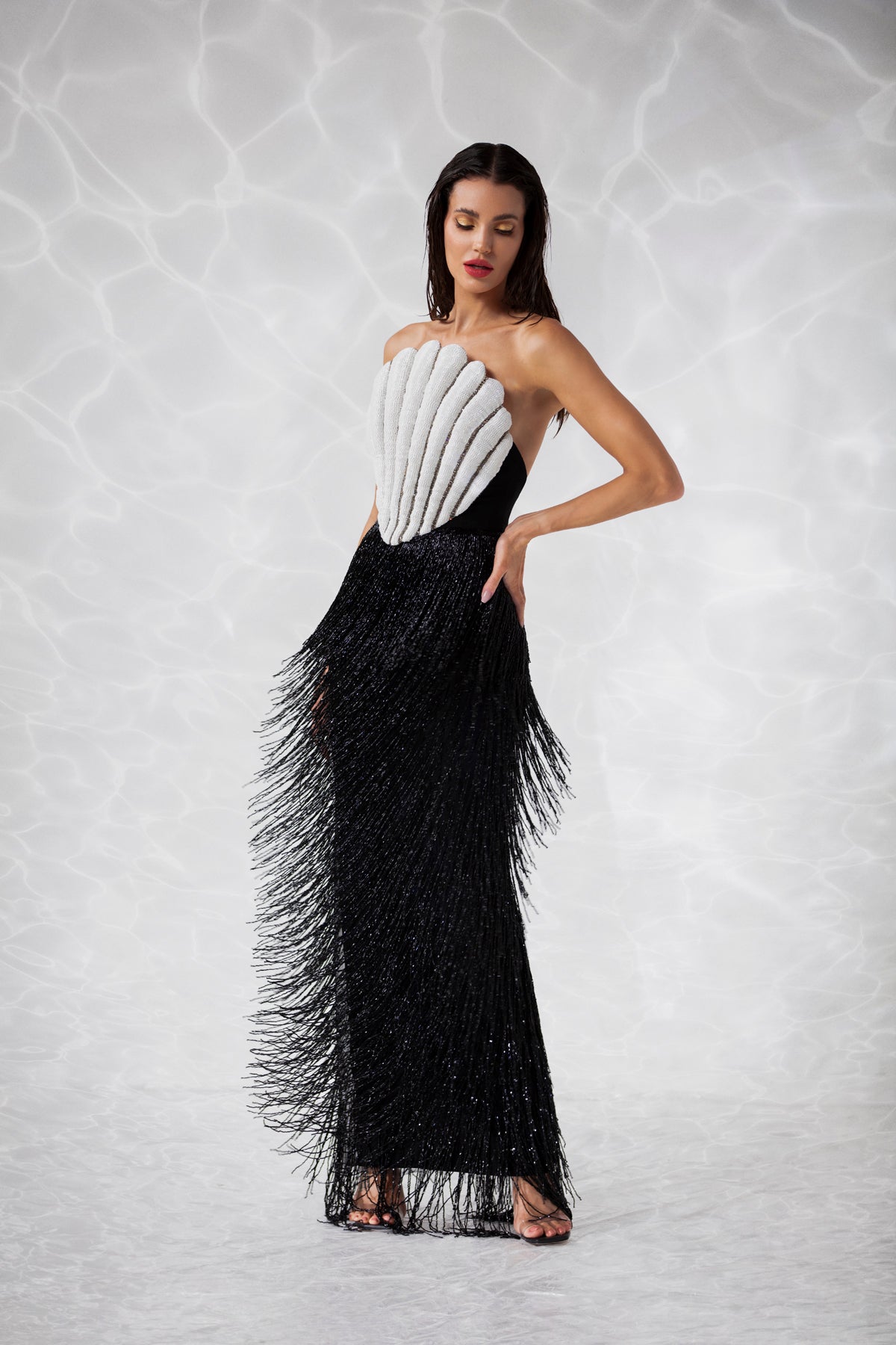 Scallop shell inspired dress consisting of a bustier embroidered with crystals and glass beads, a skirt in hanging beaded fringes Scallop shell inspired dress consisting of a bustier embroidered with crystals and glass beads, a skirt in hanging beaded fringes