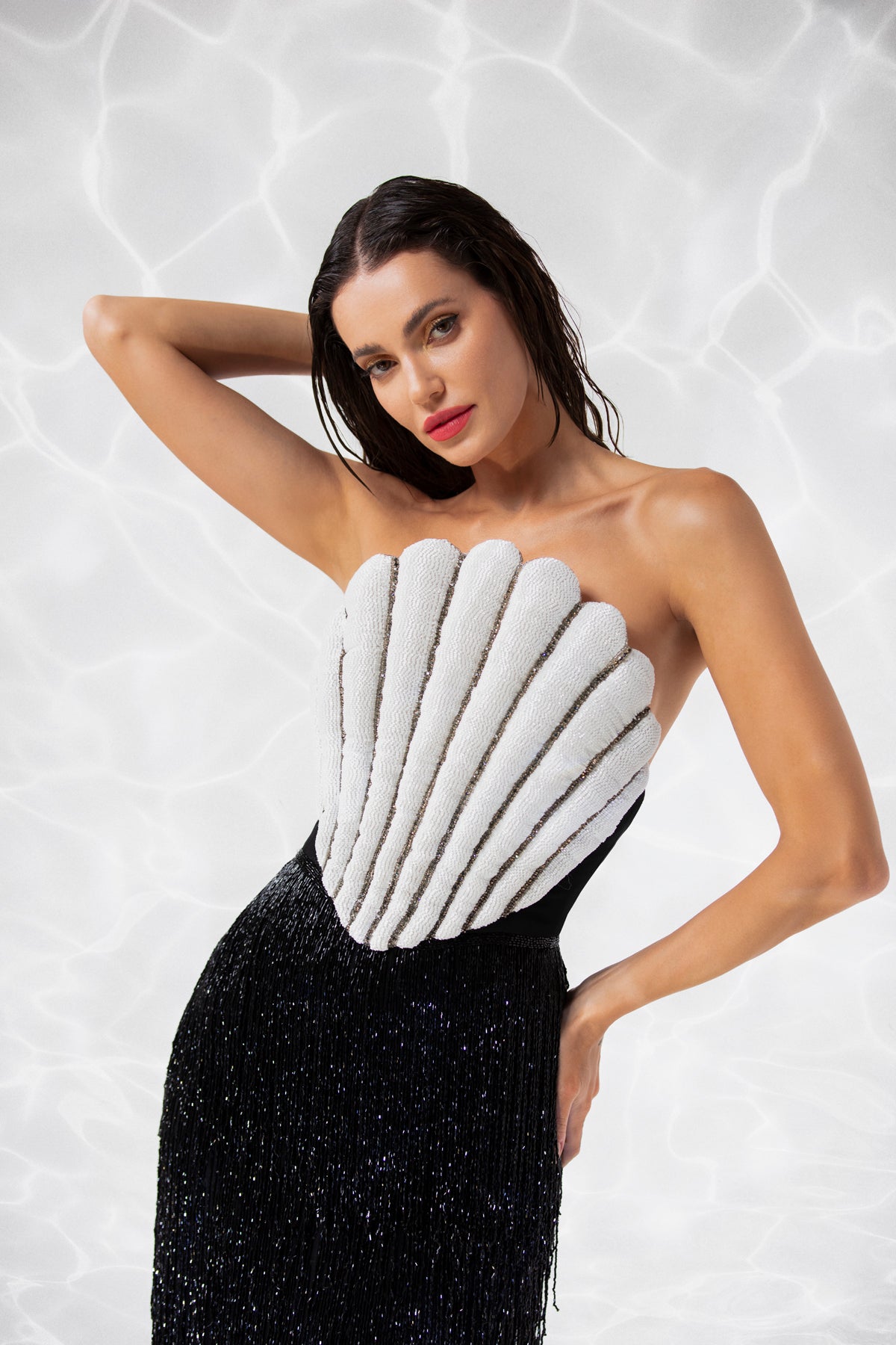 Scallop shell inspired dress consisting of a bustier embroidered with crystals and glass beads, a skirt in hanging beaded fringes Scallop shell inspired dress consisting of a bustier embroidered with crystals and glass beads, a skirt in hanging beaded fringes