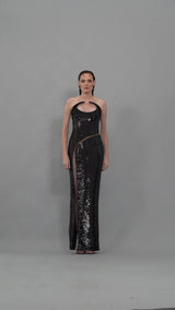 Structured black sequins dress with pointed neckline and sheer black tulle
