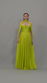 Lime green draped dress in silk foiled tulle with gloves and chains