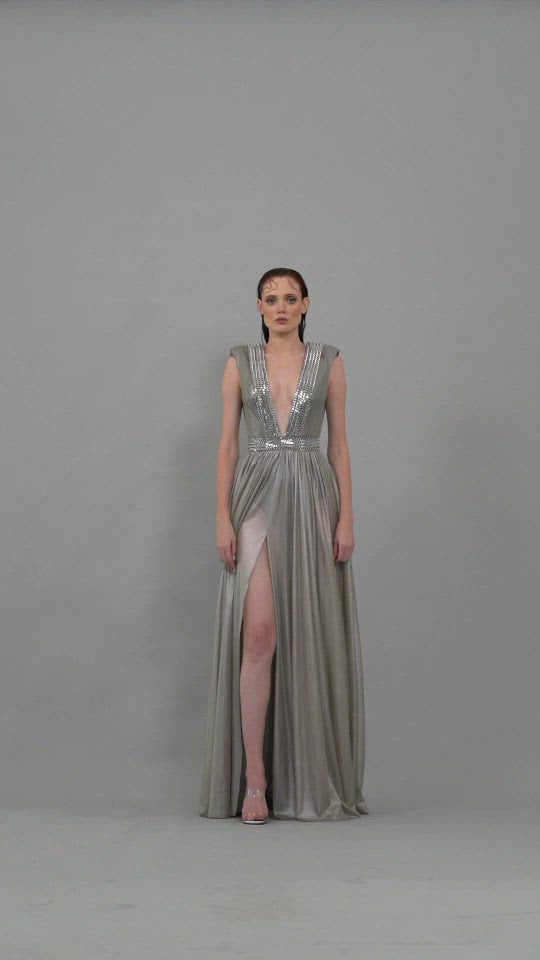 Silver dress with chains, plunging neckline and structured shoulders