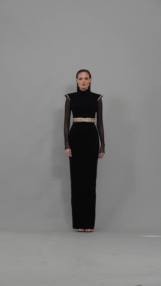 Black crêpe dress with structured shoulder, tulle sleeves and chain belt