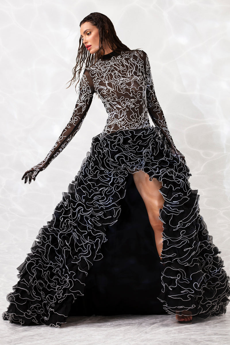 Black sheer gown with built in gloves embroidered with waves of white silk threads and micro beads and a ruffled skirt in silk organza