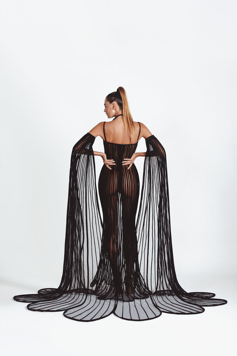 Mermaid signature dress in black latex and tulle worn with cape sleeves handcrafted in 3D tubes