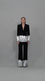 Structured black suit with silver painted feathers and open back