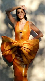 Sequined orange dress with front bow
