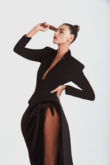 Structured tailored jacket-dress in black silk crêpe with latex lapels and a deconstructed side seam ruffle embellished with natural iridescent plumage 
